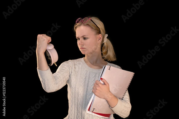 Obraz Frustrated Student Checking Time on Alarm Clock with Notebooks