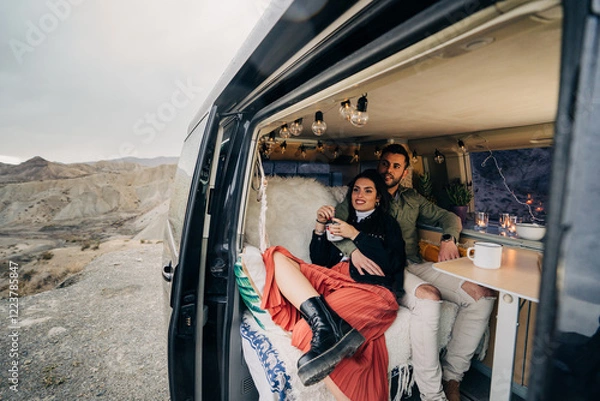 Obraz Couple enjoying camper van life in scenic desert landscape