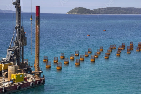 Fototapeta Platform with drilling machine building foundations of new jetty in Split harbor in Croatia