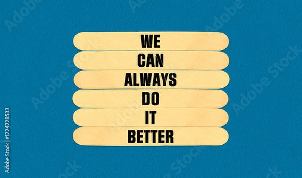 Fototapeta We Make it Better Symbol. Concept word We Can Always Do It Better on beautiful wooden stick. Beautiful Blue Chart Paper Background. Business and We Make it Better concept. Copy space