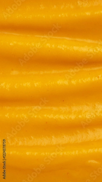 Fototapeta Butternut squash pumpkin puree soup with coconut milk close-up. The wavy texture on the surface is made using a spoon. Vegetable dish macro foto. Healthy eating concept. Vegan and vegeyerian food