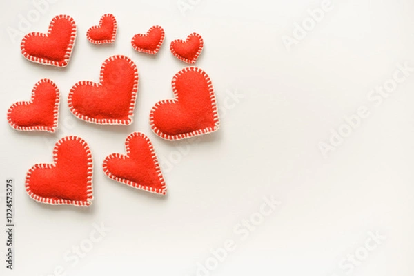 Fototapeta Red hearts on white background. Isolated hearts on white background. Valentine's Day background. Red felt hearts.
