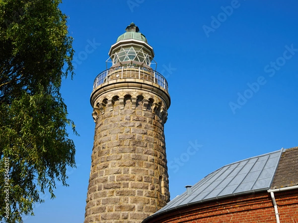 Fototapeta Old stone lighthouse on the beach