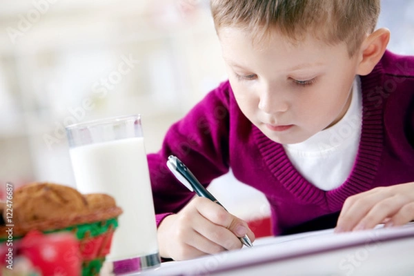 Obraz Portrait of little boy writing a letter