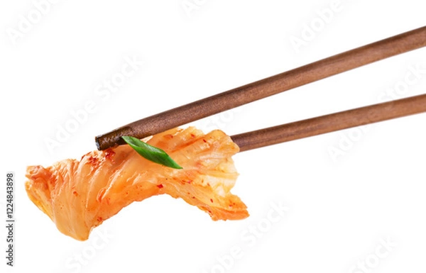 Fototapeta Chopsticks holding kimchi cabbage on white background. Hot fermented napa cabbage.