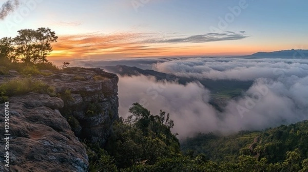 Fototapeta Breathtaking panoramic view of mountains, clouds, and trees during a stunning sunset