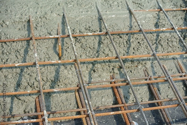Obraz The wet concrete is poured on a steel reinforcement to form strong floor slabs.