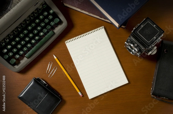 Fototapeta Blank steno notepad on a desk among vintage journalism props