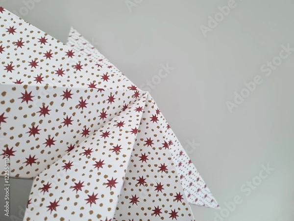 Fototapeta Christmas paper star with a festive pattern. Festive background against the ceiling. Abstract background with a December holiday motive.