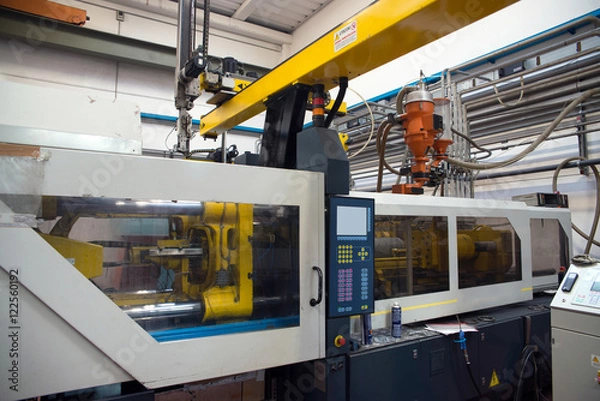Fototapeta Injection molding machines in a large factory