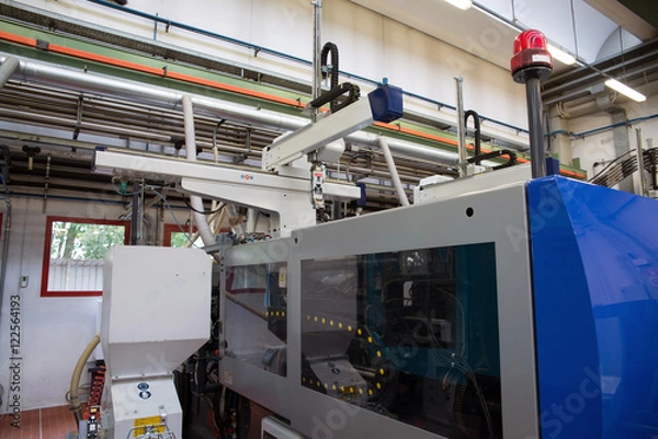 Fototapeta Injection molding machines in a large factory