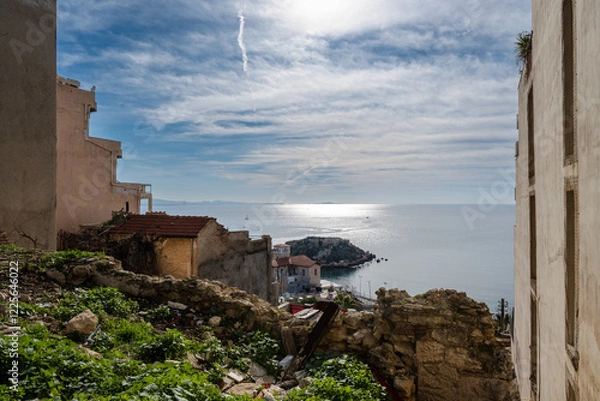Fototapeta View of the sea from the top of the  Kastella cliff at Piraeus-Greece on a sunny day with clouds at the sky.