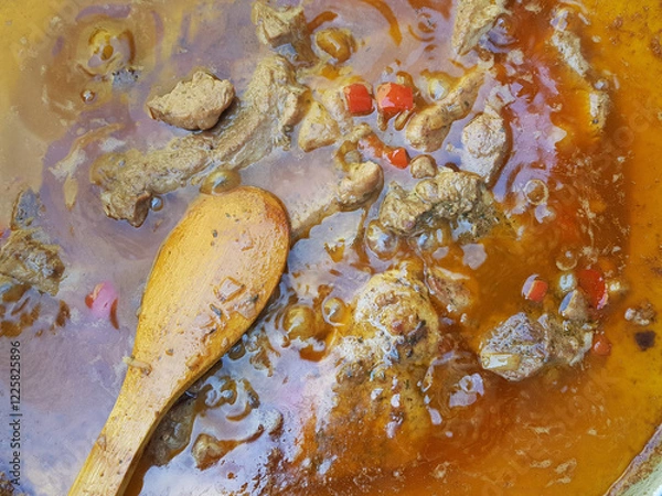 Obraz Close-up of bubbling beef stew with wooden spoon