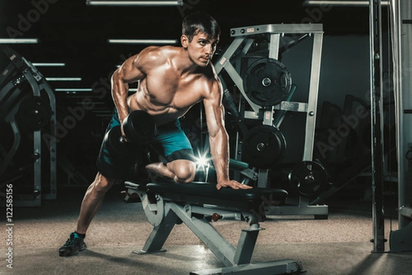 Fototapeta sport, fitness, lifestyle and people concept - flexing muscles with dumbbells in gym