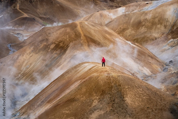 Obraz Scenic aerial drone view of a man hiker in red jacket and foggy Kerlingarfjoll mountain path amidst desert and snowy terrain in Iceland