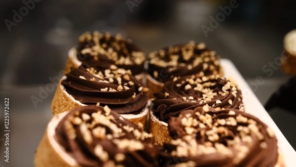 Fototapeta chocolate tart crushed peanut topping in buttery shortcrust pastry basket on white plate placed on counter perfect for dessert lovers indulgent treat rich texture sweet pastry close up festive