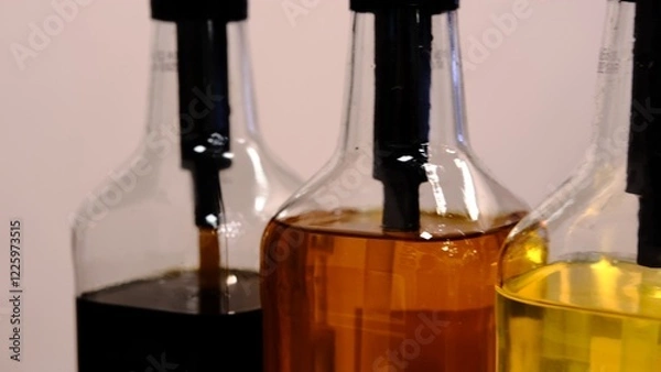 Fototapeta Colorful syrups in glass bottles captured close up with vibrant lighting highlighting the variety of shades and textures perfect for beverages desserts and culinary creations offering a visual treat