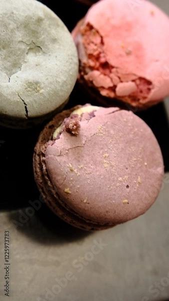 Fototapeta Damaged colorful macarons in close-up showing imperfections and cracks caused by poor transportation highlighting delicate texture of the dessert and the impact of improper handling on fragile treats
