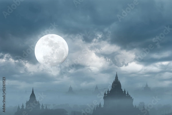 Fototapeta Amazing castle silhouette under moon at mysterious night. Fantasy  background in vintage style with old Buddhist Temples Sulamani and Tha Beik Hmauk Gu Hpaya at Bagan Kingdom, Myanmar (Burma)