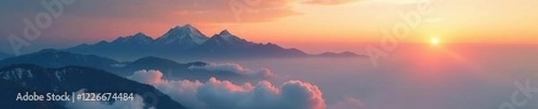 Fototapeta Softly swirling clouds float above mountain peaks at golden hour, sunset, soft focus