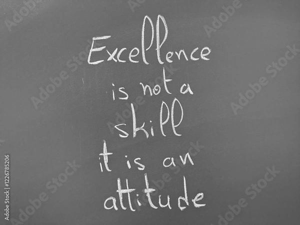 Fototapeta Excellence is not a skill it is an attitude written on a chalkboard in bold handwriting