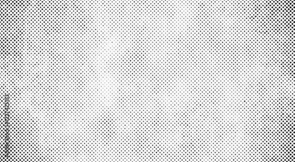 Fototapeta Vector halftone background with a black and white dotted subtle grunge vignette. Retro minimal backdrop design.