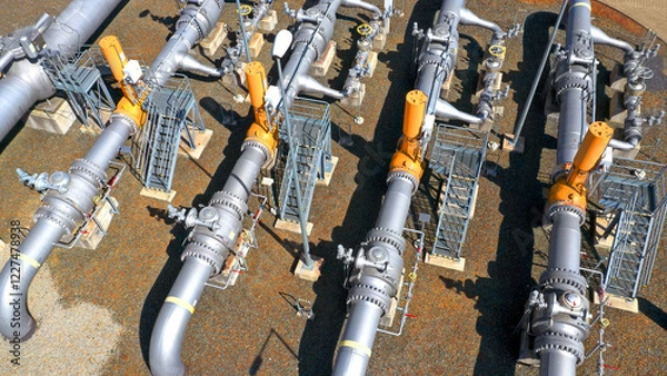 Fototapeta Natural gas pipeline in European Union. High pressure pipes on a hot summer day.	
