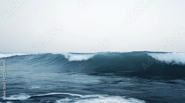 Fototapeta Serene ocean waves against a tranquil sky with a subtle gradient of blue and grey, creating a calming natural landscape backdrop.