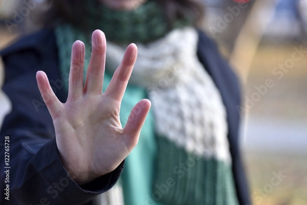 Obraz Woman put forth a hand in stopping gesture
