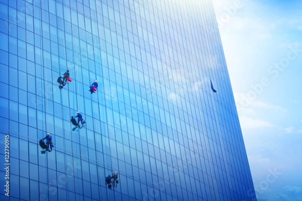 Fototapeta A Team Of Climbing Workers Clean the Windows on Skyscraper