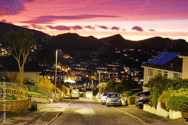 Fototapeta Skyline of Ilfracombe in North illuminated at dusk