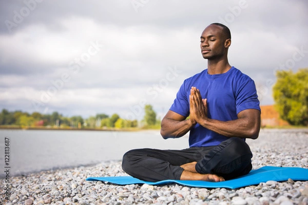Obraz young man exercising yoga