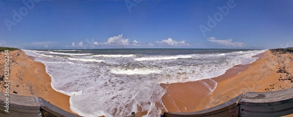 Obraz Panoramic beach view of sea foam and ocean surf rolling in over a deserted Flagler Beach, Florida, USA.