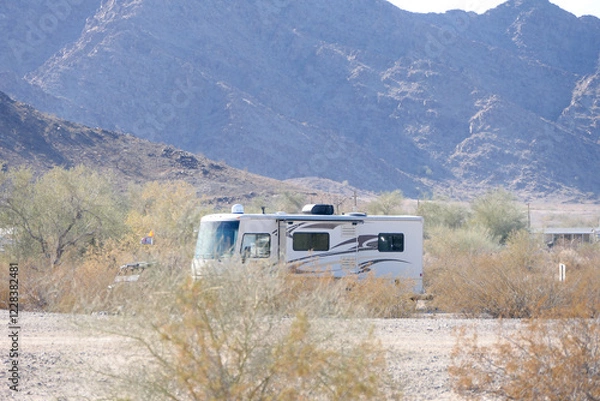 Obraz Lone A-Class RV Camper stealth camping in the Desert Mountains
