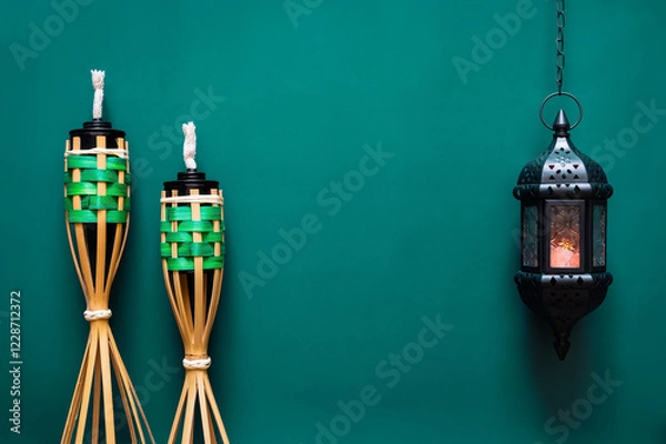 Fototapeta Pelita or know as oil lamp with hanging lantern on green background