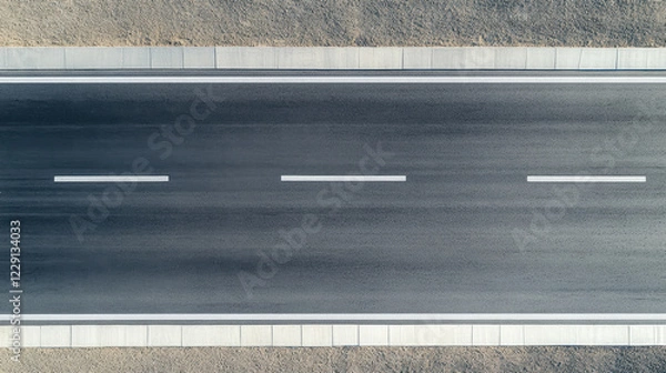 Fototapeta seamless top down view of modern asphalt highway with clear lane markings, showcasing smooth surface and surrounding gravel. image evokes sense of openness and tranquility