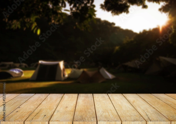 Fototapeta Wooden table top on camping ground mountain and grass field.Fresh and Relax concept.For montage product display or design key visual layout.View of copy space.