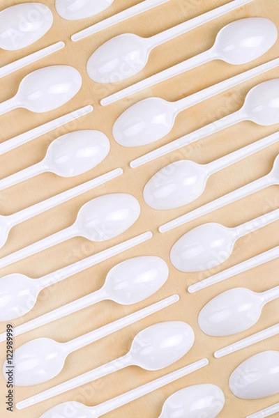 Obraz Plastic disposable white spoons on a wooden table