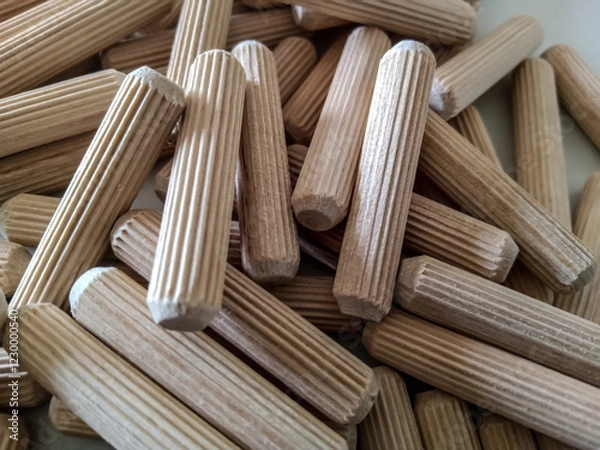 Obraz Wood dowel pins are cylindrical pieces of wood that are used to join two pieces of wood together. They are a common tool in carpentry and woodworking, and are often used in furniture.