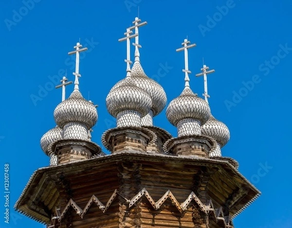 Fototapeta Domes of Church of the Intercession against deep blue sky, Kizhi Island, Russia. Ancient wooden architecture. UNESCO heritage landmark