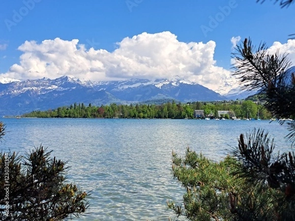 Obraz A lake in the Swiss Alps. The Blue Lake in Switzerland. Snow-capped mountains near the lake. Spring.