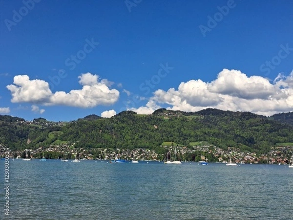 Obraz A lake in the Swiss Alps. The Blue Lake in Switzerland. Snow-capped mountains near the lake. Spring.