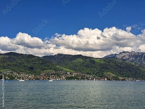 Obraz A lake in the Swiss Alps. The Blue Lake in Switzerland. Snow-capped mountains near the lake. Spring.