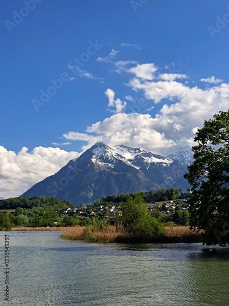 Obraz A lake in the Swiss Alps. The Blue Lake in Switzerland. Snow-capped mountains near the lake. Spring.