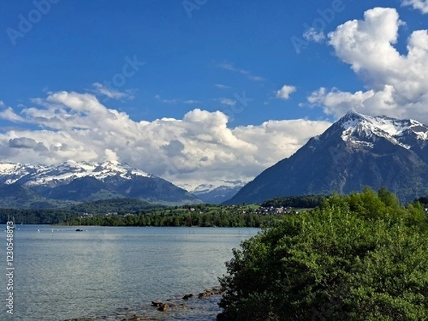 Obraz A lake in the Swiss Alps. The Blue Lake in Switzerland. Snow-capped mountains near the lake. Spring.
