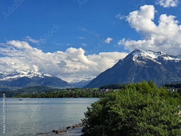 Obraz A lake in the Swiss Alps. The Blue Lake in Switzerland. Snow-capped mountains near the lake. Spring.
