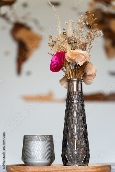 Fototapeta Still life with artificial roses and candle as a center table decoration.