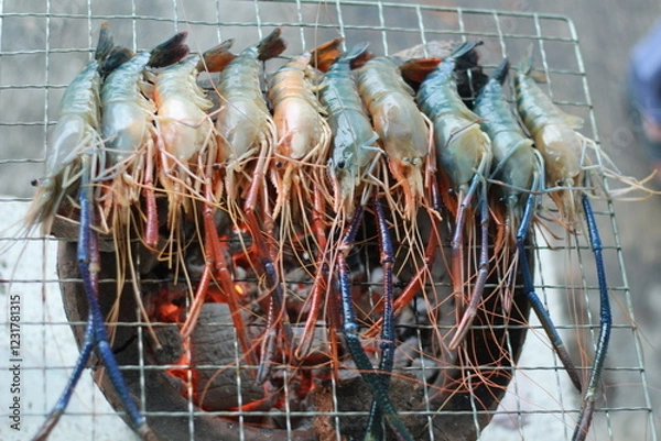 Obraz  Raw Shrimp on Grill with Charcoal Background