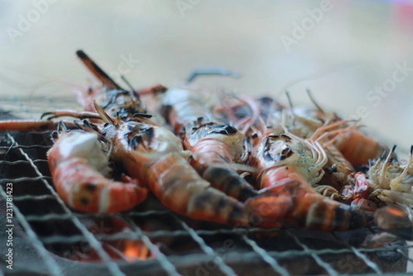 Obraz  Raw Shrimp on Grill with Charcoal Background