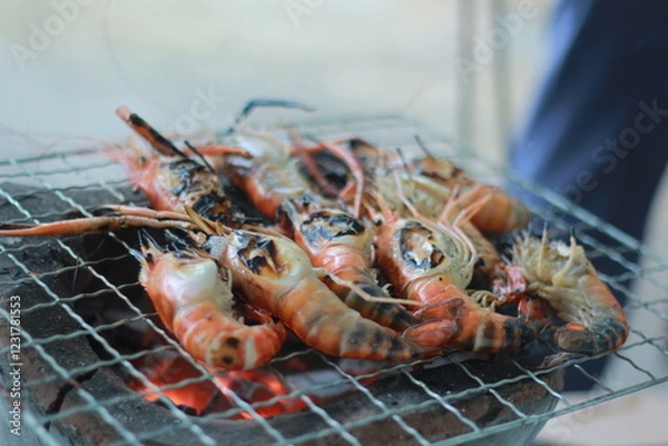 Obraz  Raw Shrimp on Grill with Charcoal Background